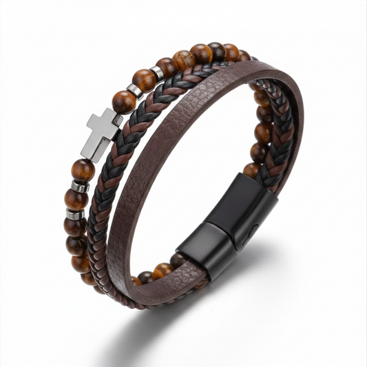 Brown leather and beaded bracelet with a cross charm on a white background