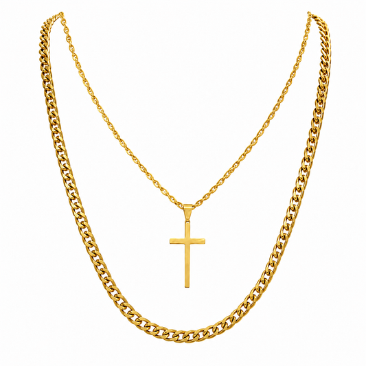 A gold-toned layered necklace set featuring a thick curb chain and a thinner chain with a small cross pendant, displayed against a solid white background.