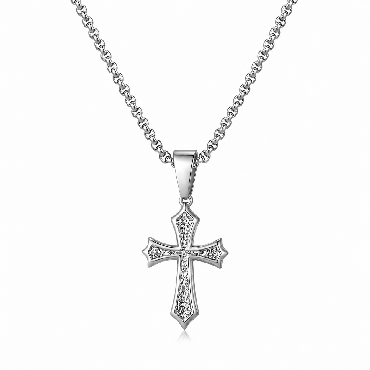 A silver cross pendant necklace with a detailed, textured cross design and clear stones, suspended from a classic curb chain against a plain white background.