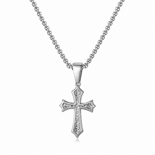 A silver cross pendant necklace with a detailed, textured cross design and clear stones, suspended from a classic curb chain against a plain white background.