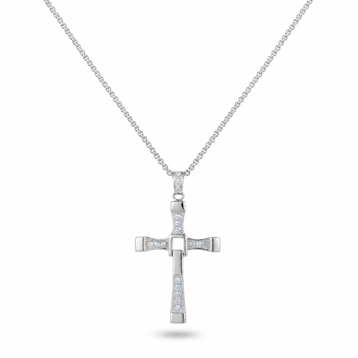 A silver cross pendant necklace adorned with small clear stones, suspended from a delicate silver chain against a plain white background.