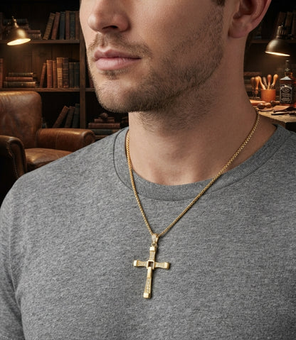 Close-up of a person wearing the gold cross pendant necklace, showing the link chain and pendant resting against their chest.