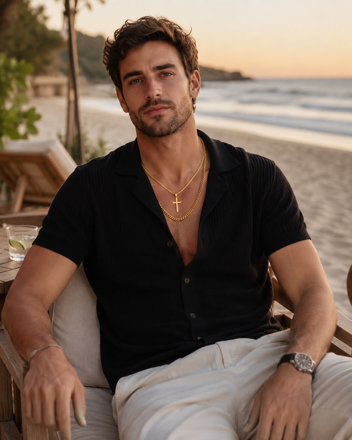 Premium gold cross pendant and curb chain layered necklace, isolated on a clean white background.