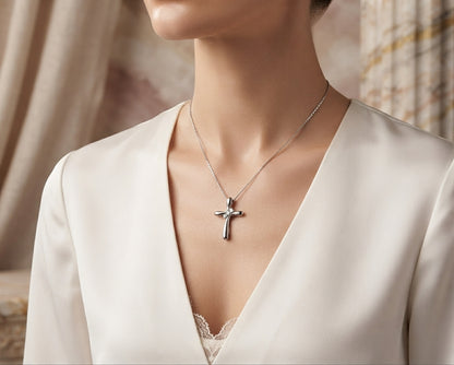 Close-up of a person wearing the sterling silver cross pendant necklace, showing the fit of the chain and the pendant resting elegantly against their neckline.