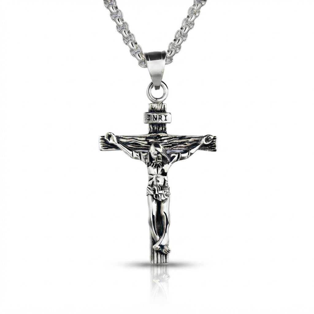 Polished sterling silver crucifix cross pendant featuring a detailed figure of Christ and INRI inscription, hanging against a clean white background.