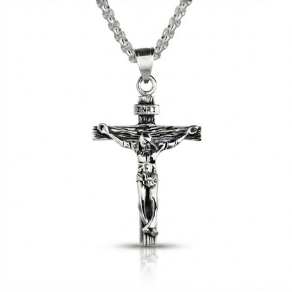 Polished sterling silver crucifix cross pendant featuring a detailed figure of Christ and INRI inscription, hanging against a clean white background.